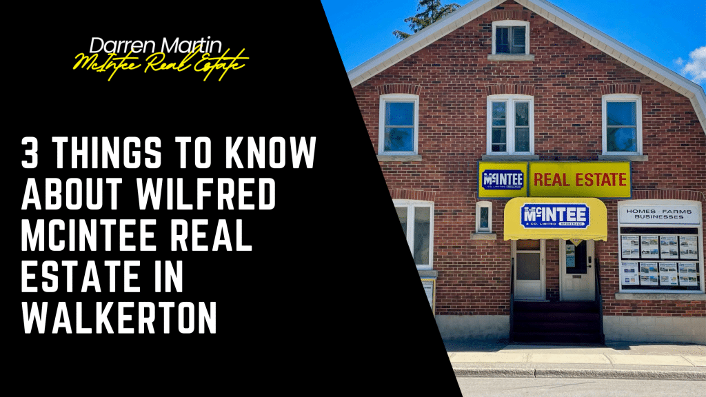 A brick building with signs reading "Wilfred McIntee Real Estate in Walkerton" and window displays featuring real estate listings.