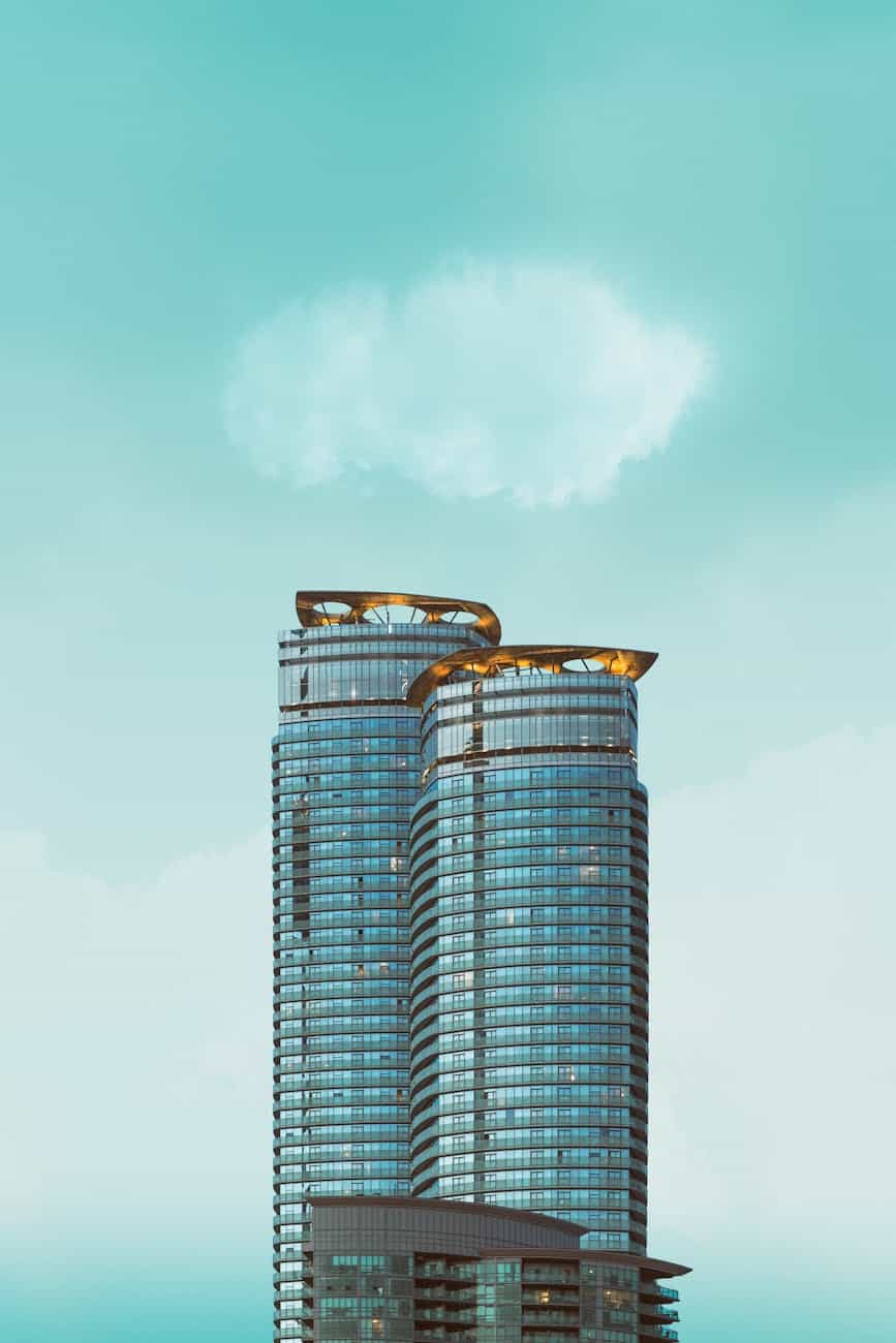 Capture of sleek, modern skyscrapers in Toronto's urban landscape under a bright blue sky.