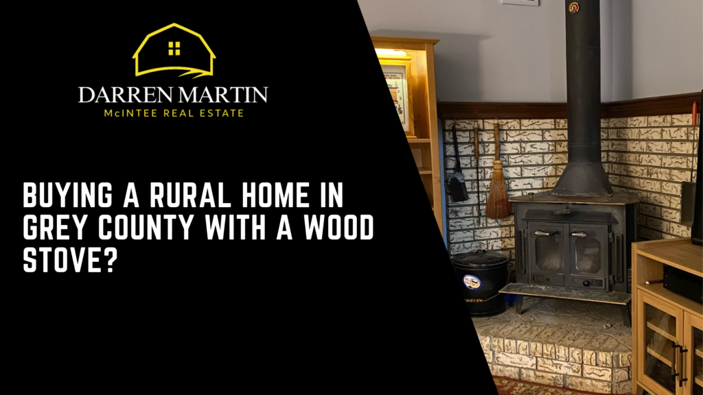 A wood stove is installed against a brick wall in a rural home living room. Text discusses buying a rural home in Grey County with a wood stove, featuring a real estate company logo.