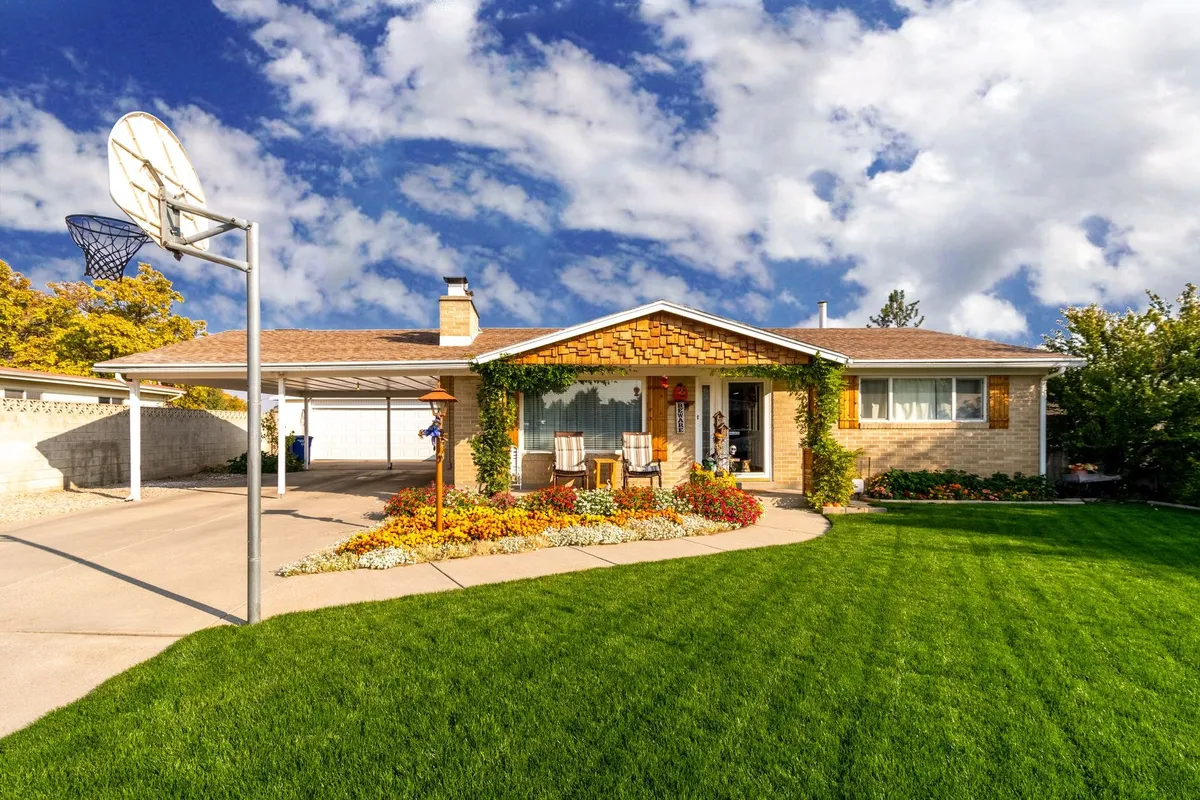 A charming suburban home with a green lawn under a clear blue sky, reflecting the appeal of West Grey real estate.