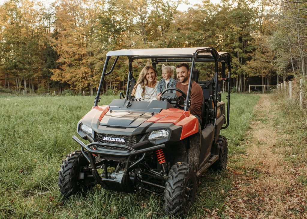 Darren Martin with his wife and daughter in their UTV on the family farm
