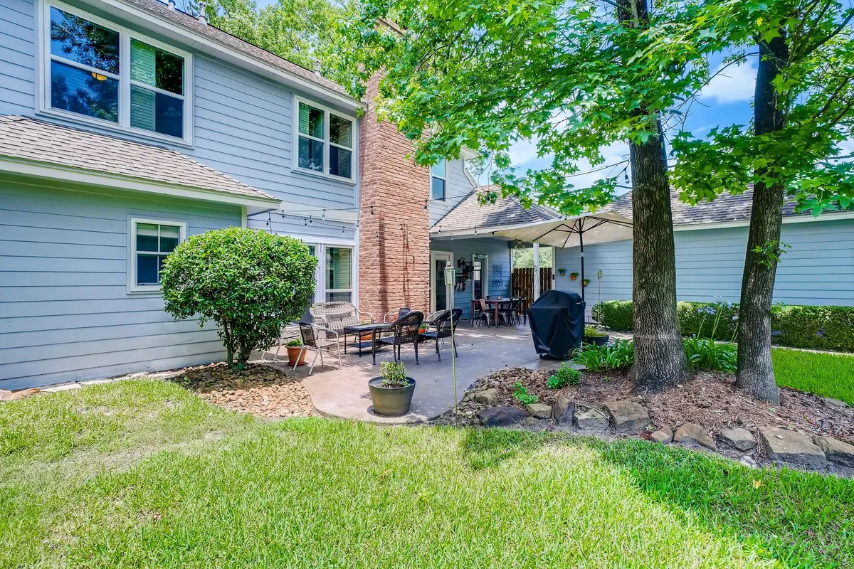 A cozy patio surrounded by lush greenery, highlighting the charm of West Grey residential properties.
